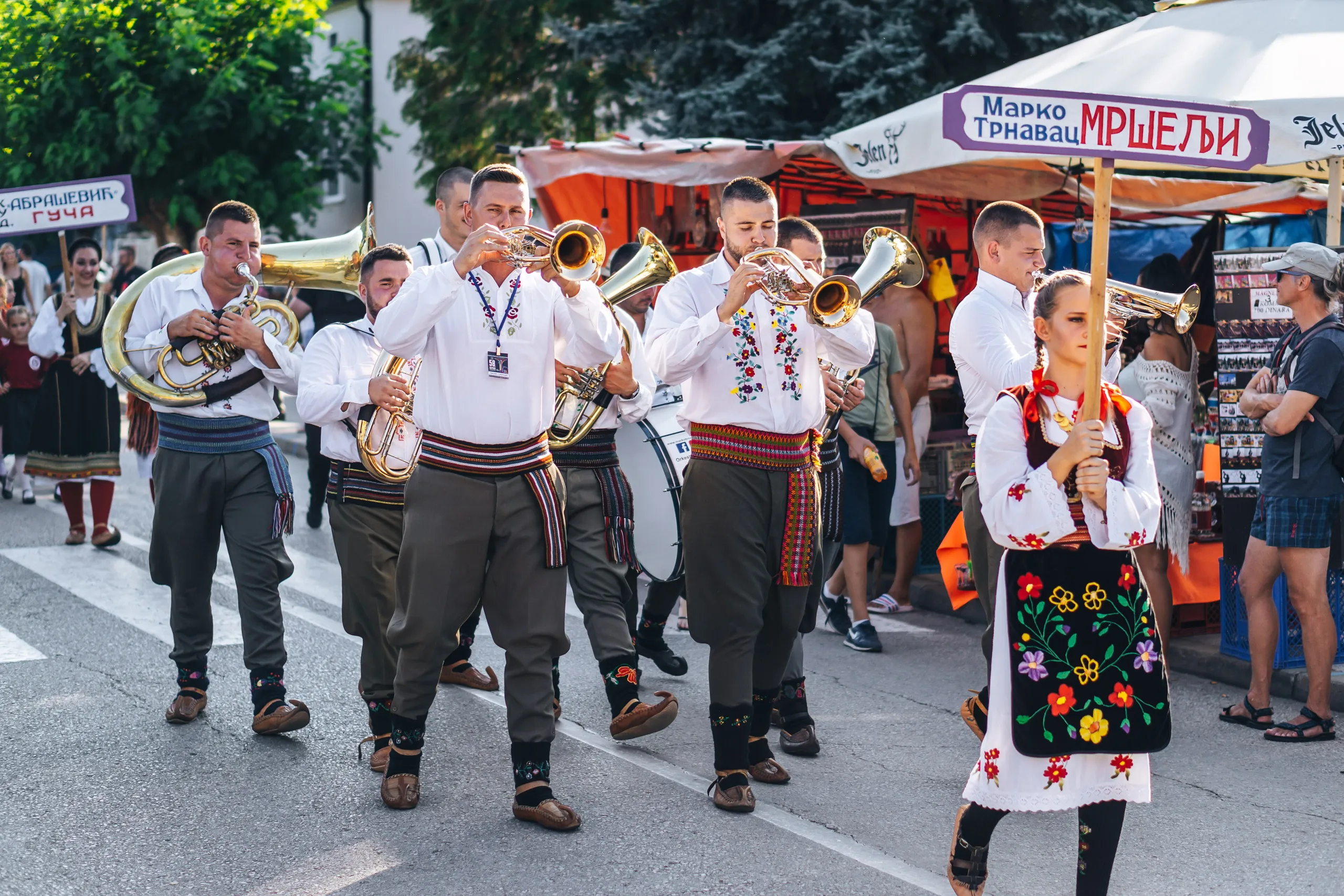 A brass band in folk costume parading at the Guča trumpet festival