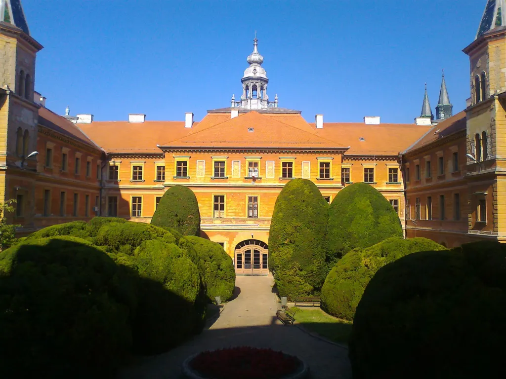 The yellow baroque County Hall (Županija) in Sombor behind its clipped garden