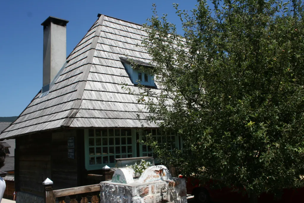 A shingle-roofed timber house in Drvengrad above the Mokra Gora valley