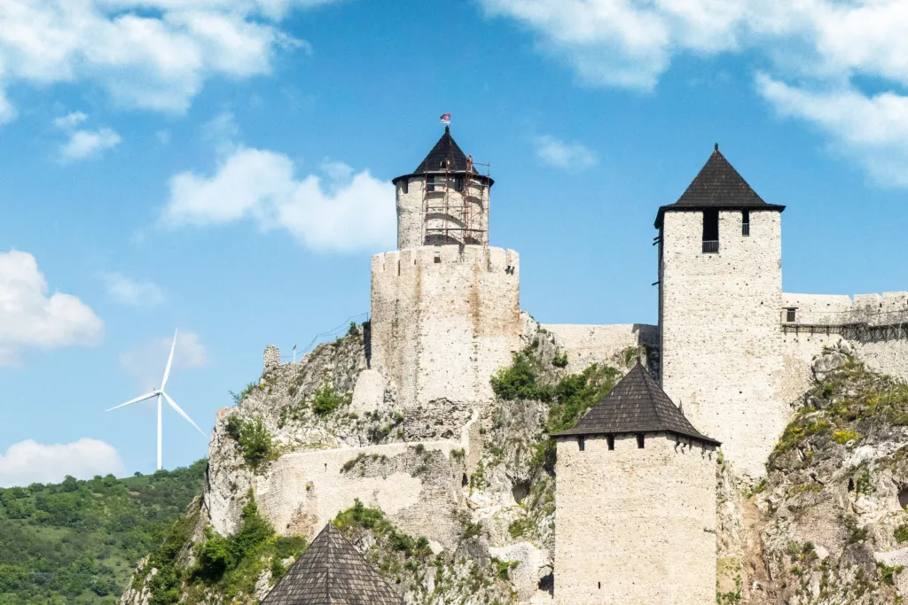 The restored stone towers of Golubac Fortress against a blue sky