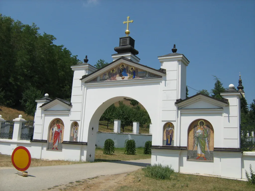 The white gate and bell tower of Grgeteg Monastery on Fruška Gora