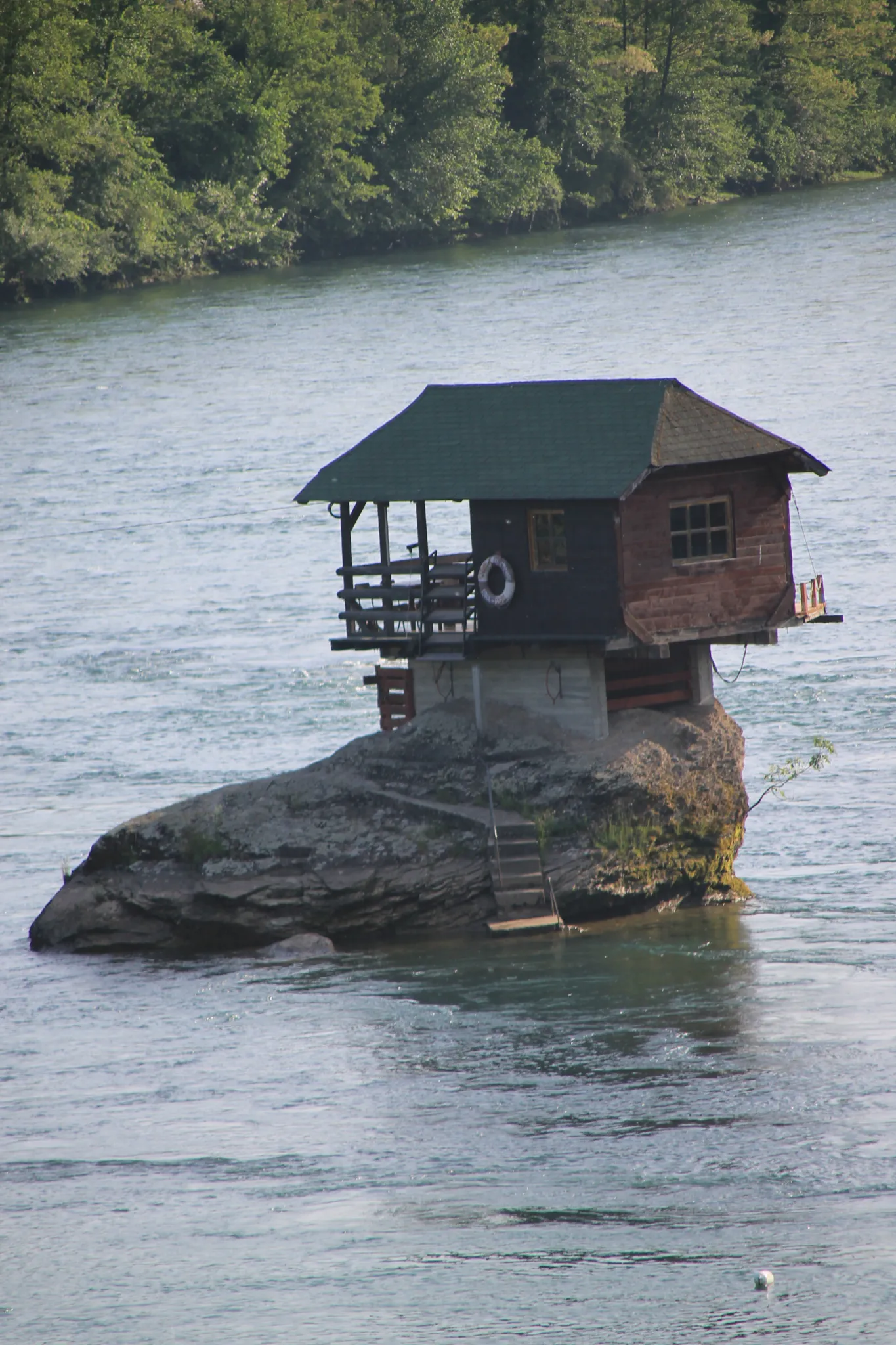 The tiny wooden house standing on a rock in the middle of the Drina near Bajina Bašta