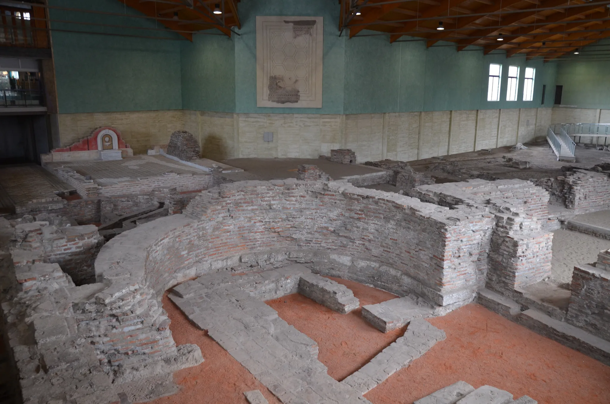 Excavated walls and floors of the Roman imperial palace of Sirmium under its protective roof