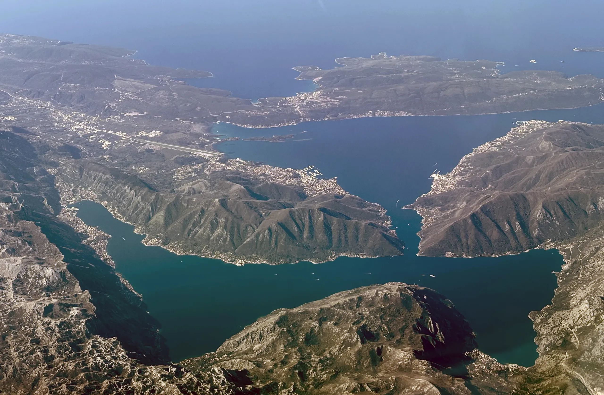 Aerial view of the Bay of Kotor, its narrow straits and mountains rising from the water, Montenegro
