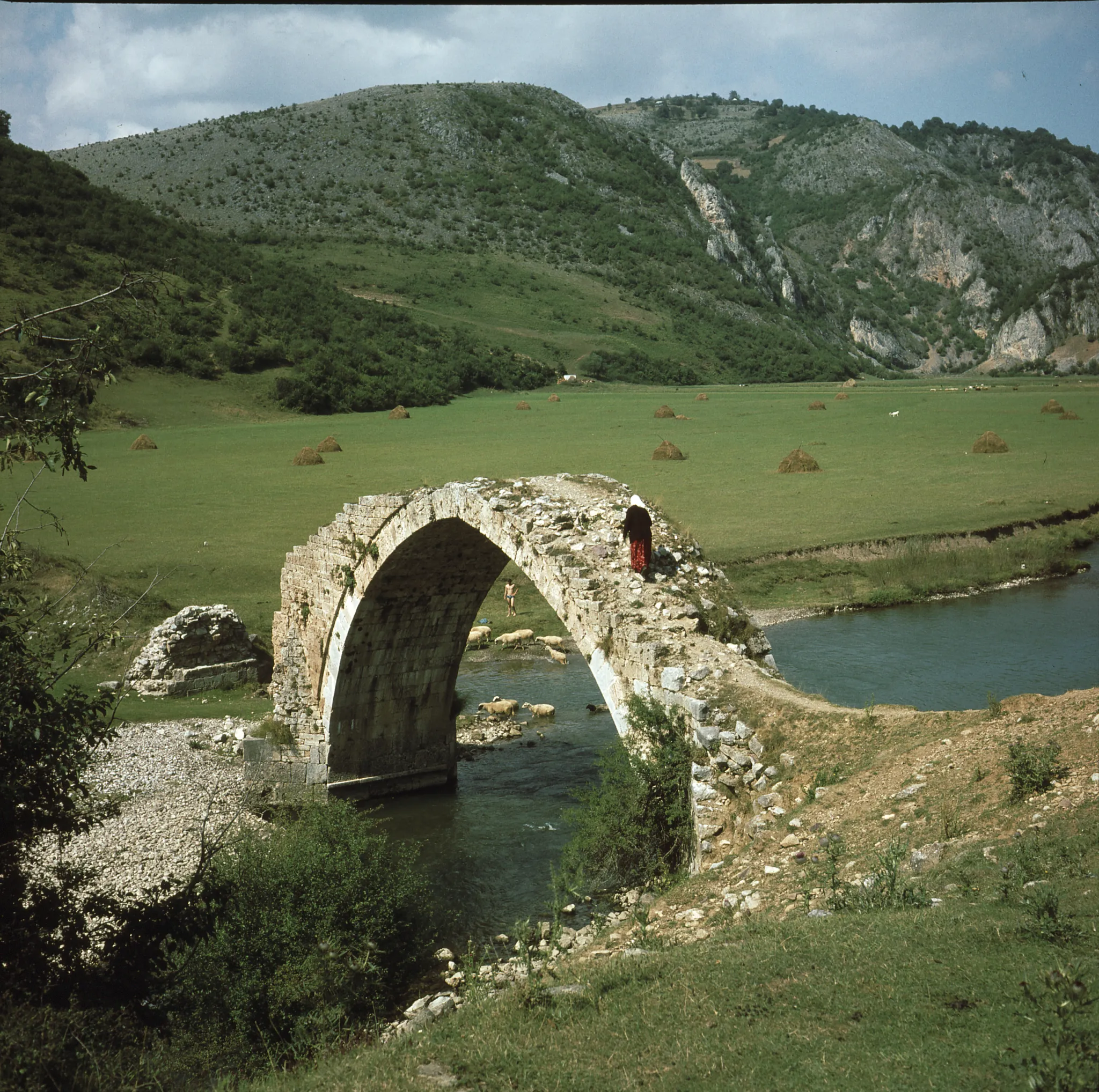 A single-arch stone bridge over the Uvac at Žvale, revealed when the lake level is low
