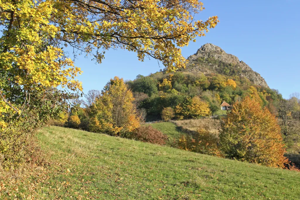 The rocky cone of Ostrvica rising above autumn woods on Rudnik
