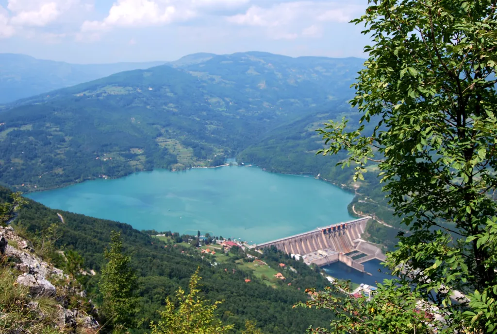 The turquoise Perućac Lake held back by its dam in the Drina canyon, seen from the Tara cliffs