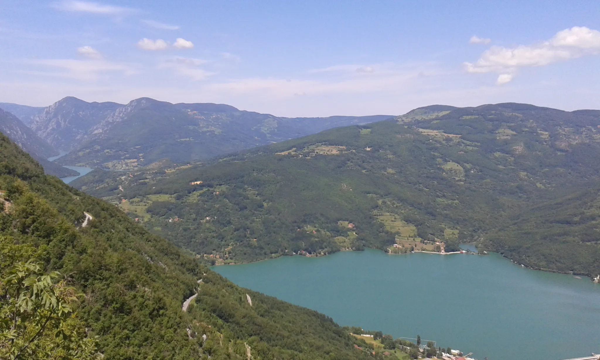 Perućac Lake filling the Drina canyon between forested mountains