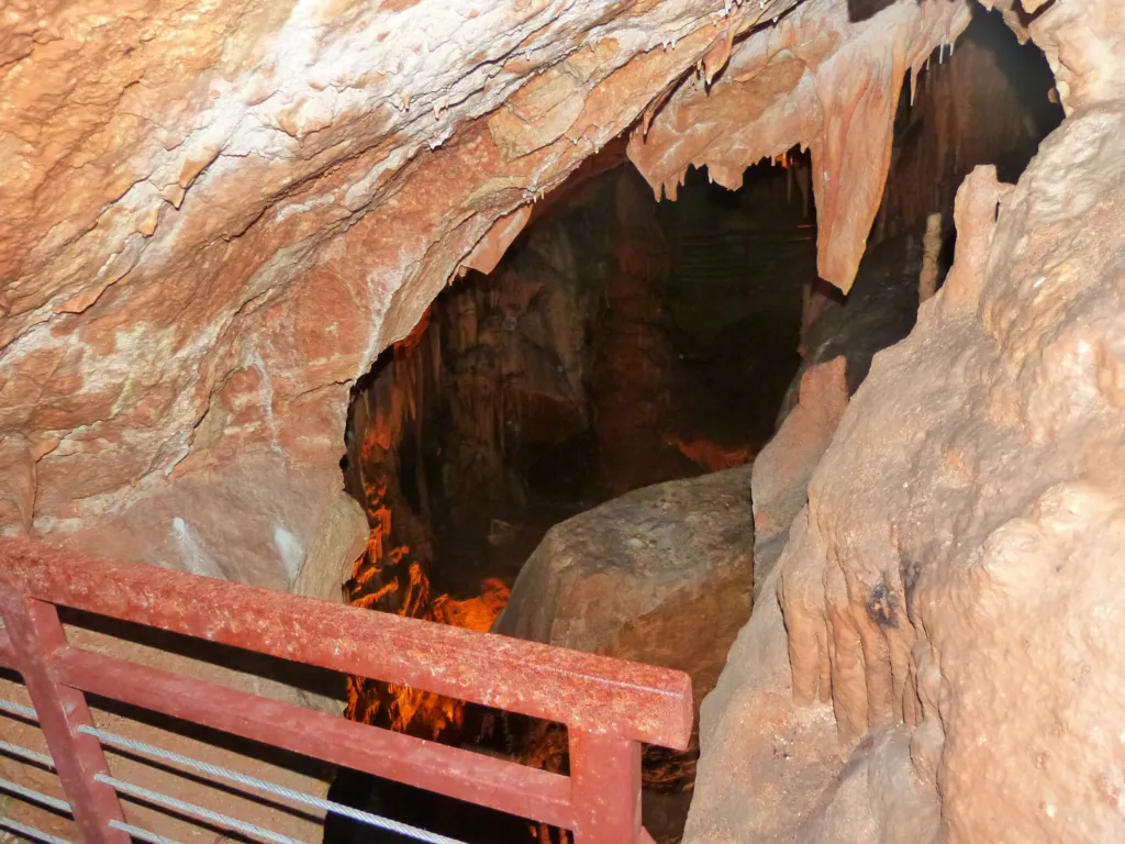 A lit passage with walkway inside Resava Cave