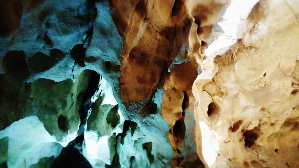 Blue-lit flowstone and calcite formations in Resava Cave