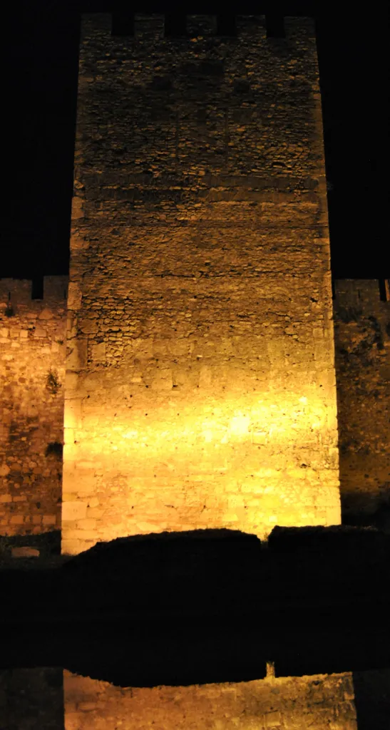 A floodlit tower of Smederevo Fortress with a stone cross set in its wall