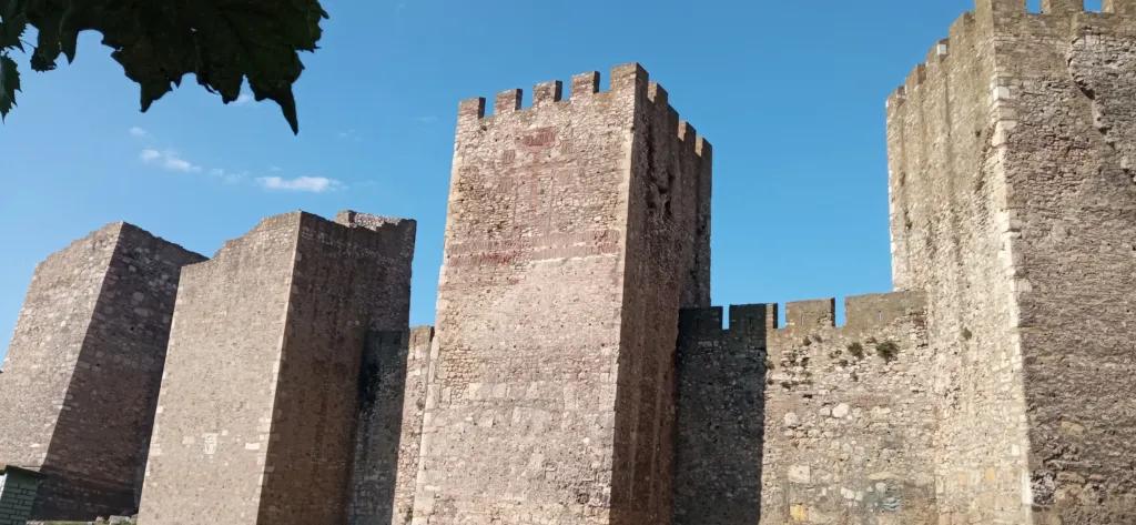 Massive square towers and curtain walls of Smederevo Fortress under a blue sky