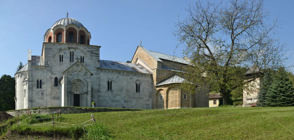 The marble churches of Studenica Monastery on their green lawn