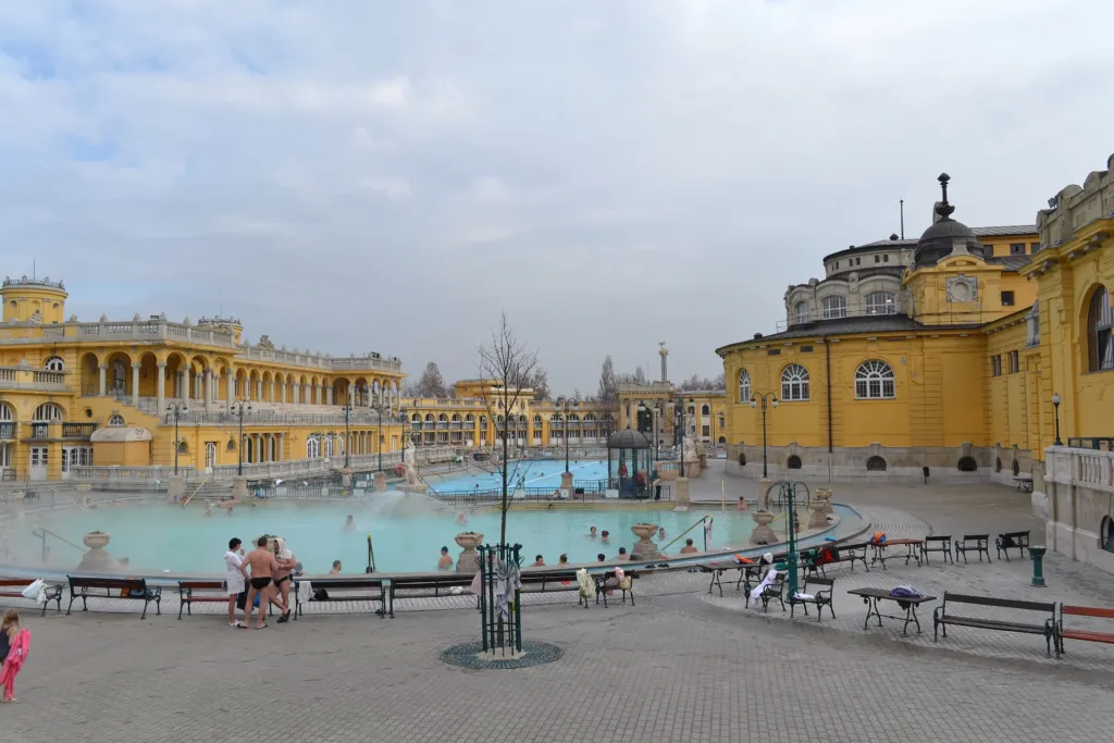 The outdoor pools and yellow neo-Baroque halls of the Széchenyi thermal bath in Budapest