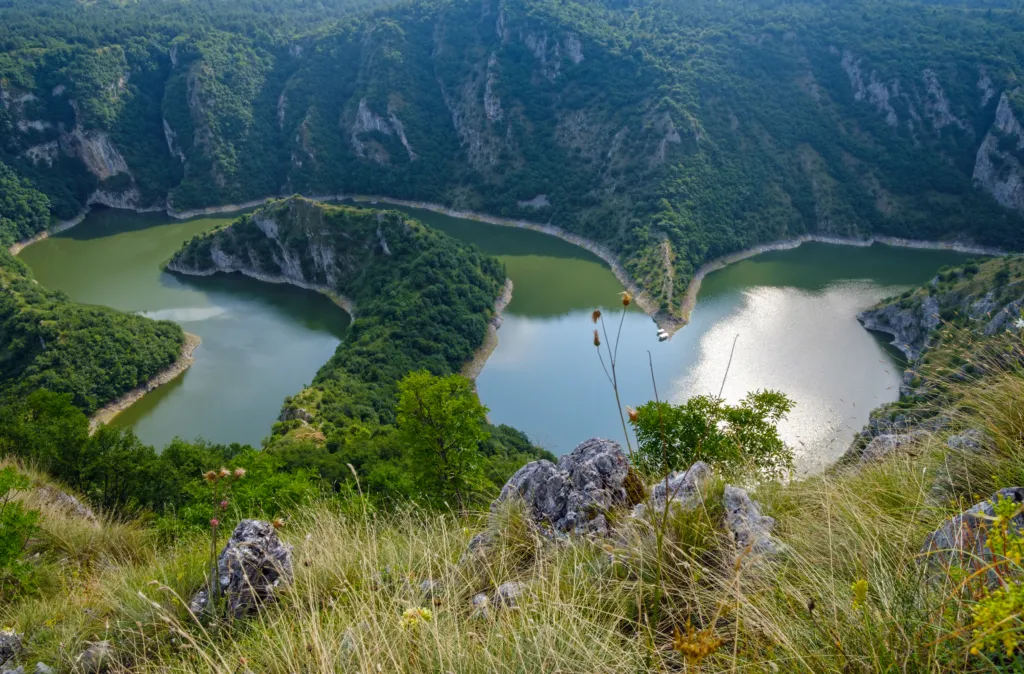 A meander of the Uvac river between steep wooded slopes, seen from above