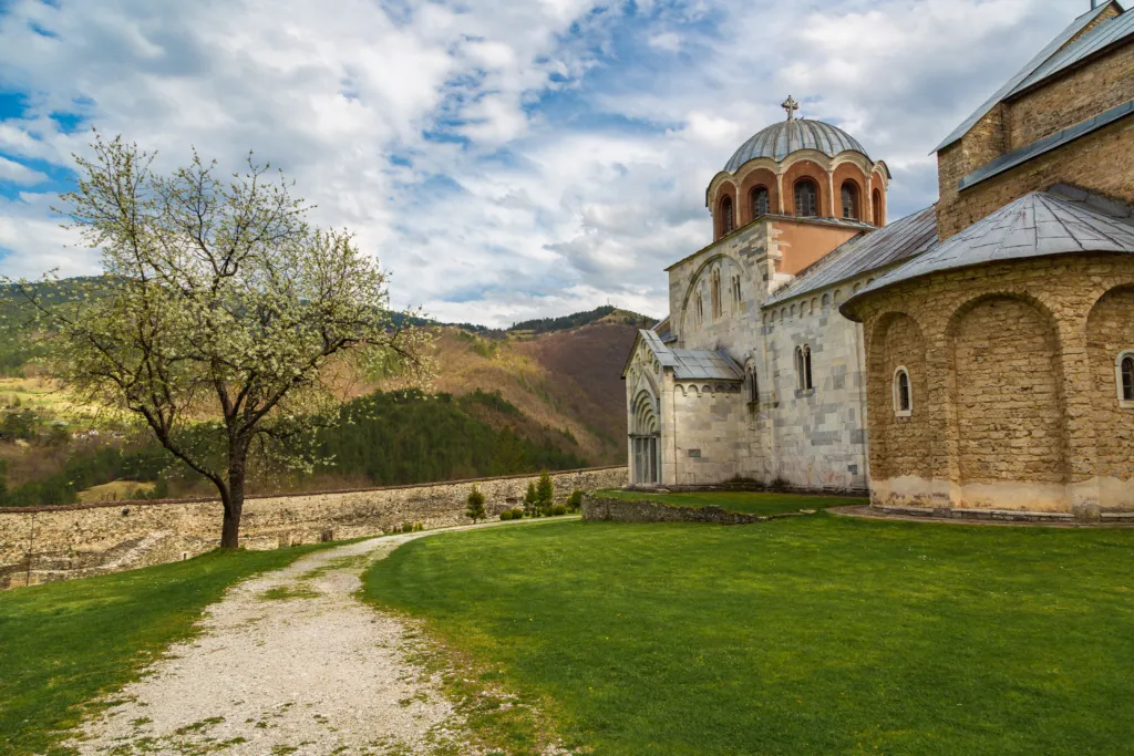 The marble Church of the Virgin at Studenica Monastery, seen across the meadow in its valley