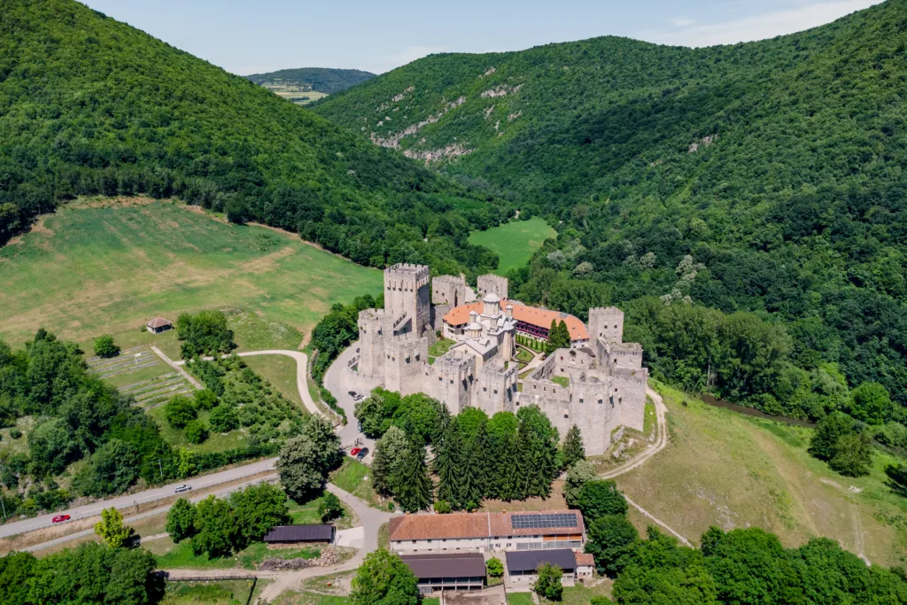 Aerial view of Manasija Monastery, its medieval walls and towers enclosing the church in a wooded valley