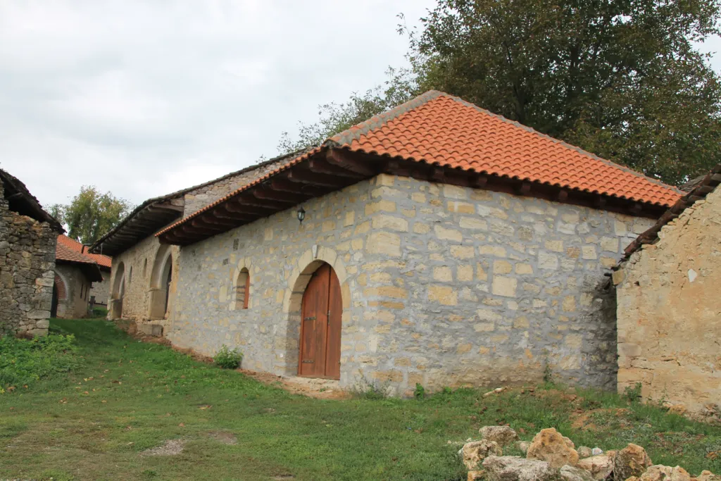 A stone wine cellar with a red-tiled roof in the Rajac pimnice village near Negotin