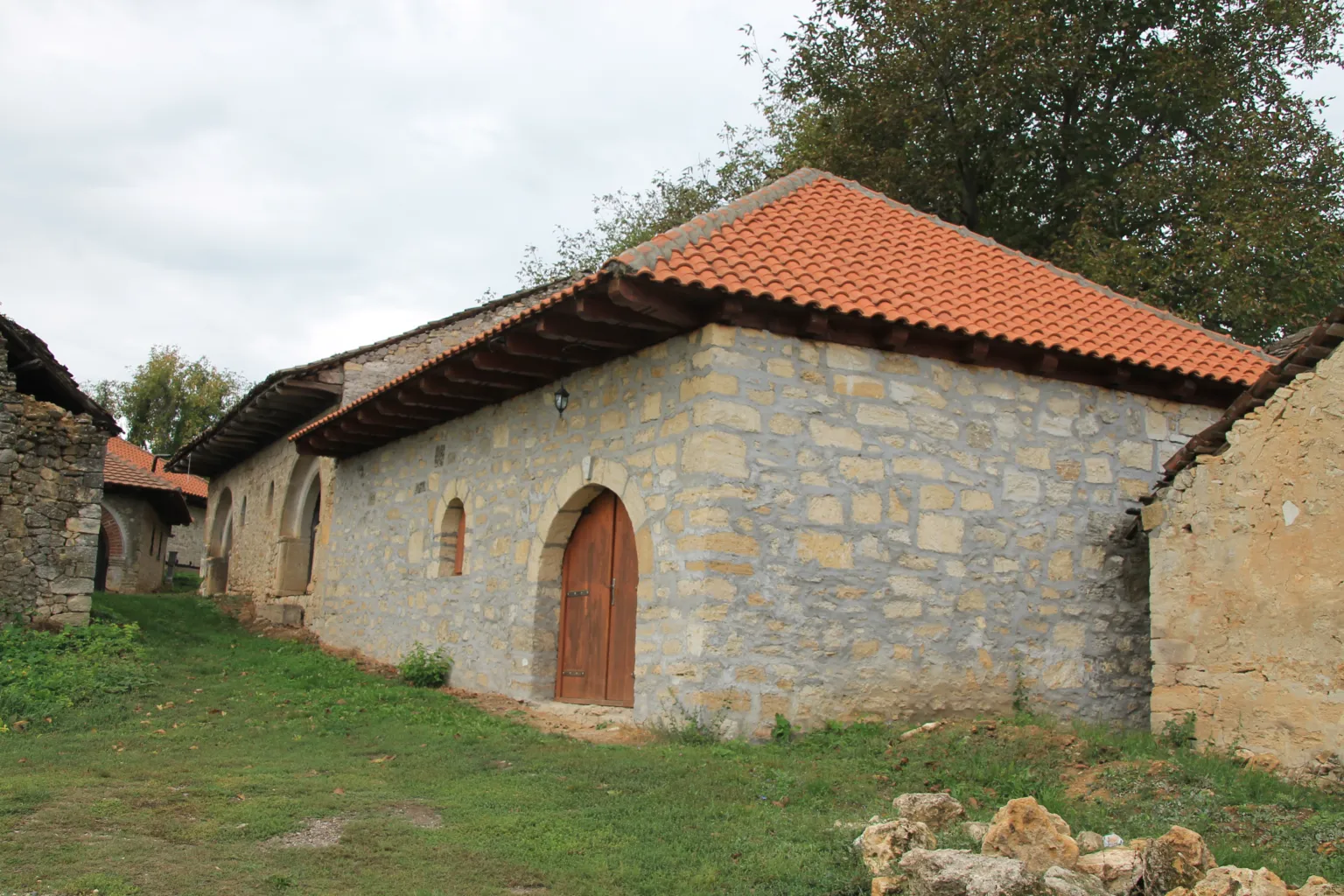 A stone wine cellar with a red-tiled roof in the Rajac pimnice village near Negotin