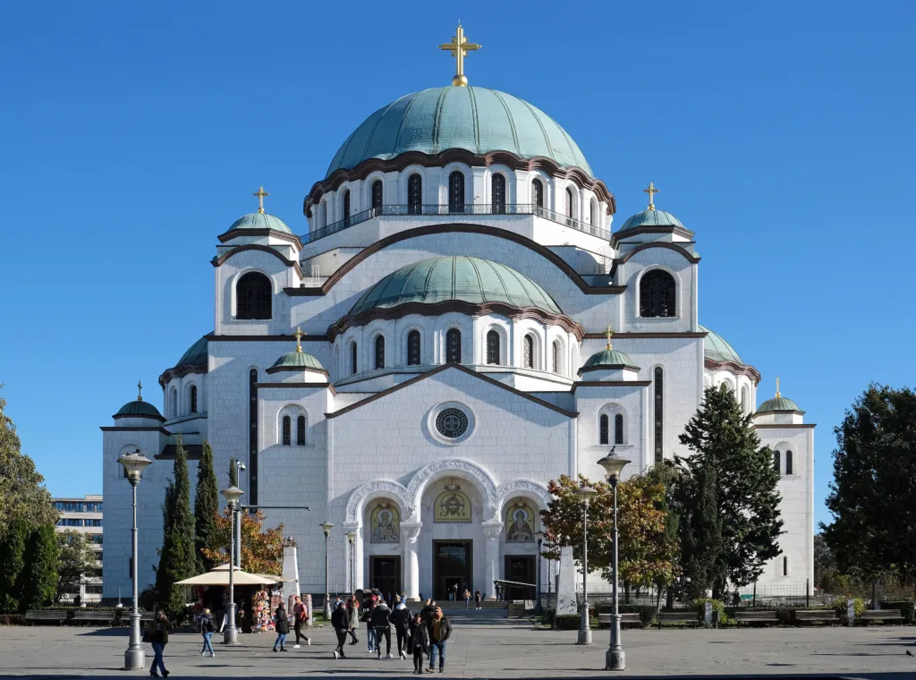 The white domes of the Temple of Saint Sava against a blue sky