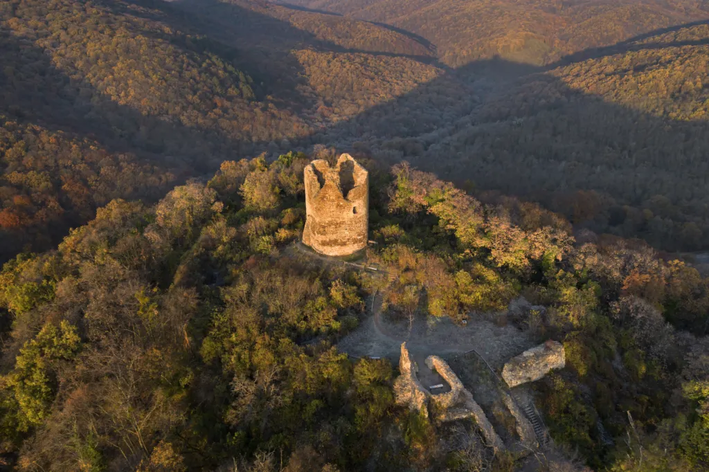 The medieval Vrdnik tower ruin on a wooded hill seen from the air