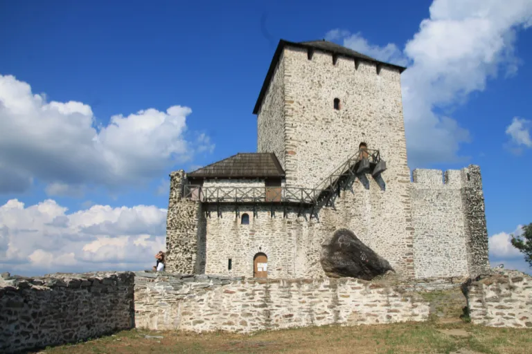 The medieval stone Vršac Tower on its hilltop above the town
