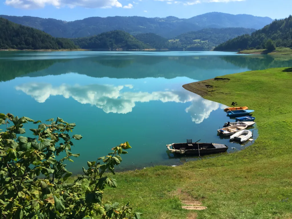 Turquoise water and moored boats on Zaovine Lake in Tara National Park